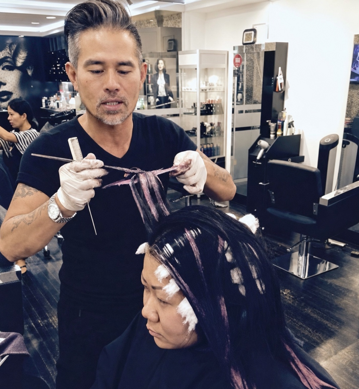 Vincent Nguyen performing a dimensional hair-color service for a client in his salon