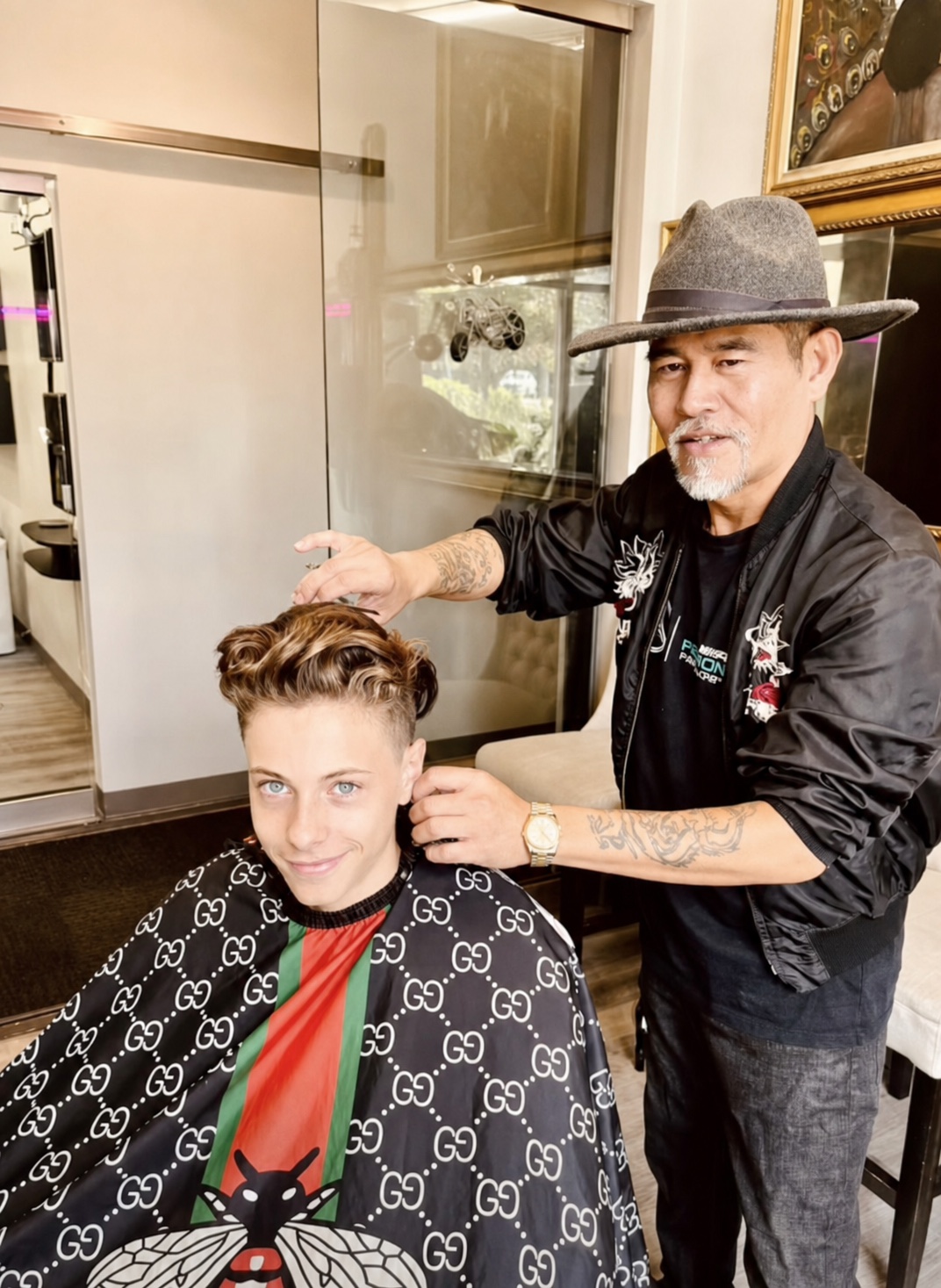 Vincent Nguyen making finishing touches to a client's sculpted short haircut