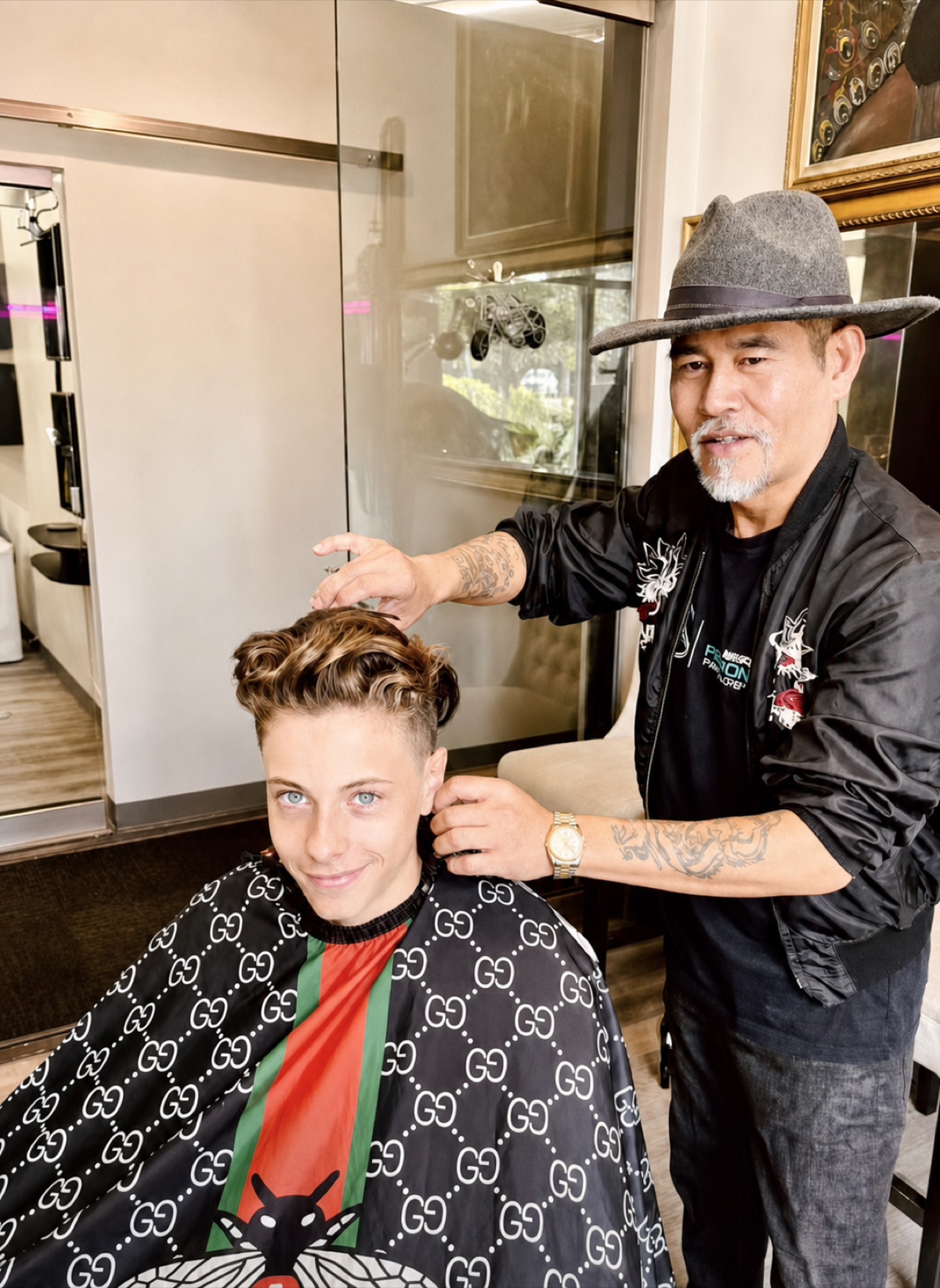 Vincent Nguyen making finishing touches to a client's sculpted short haircut