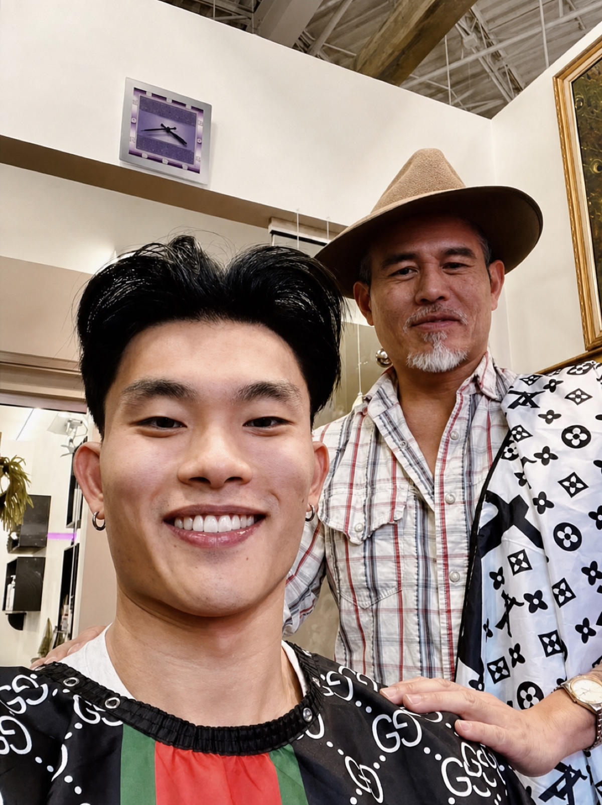 Vincent Nguyen with a smiling client after styling his haircut