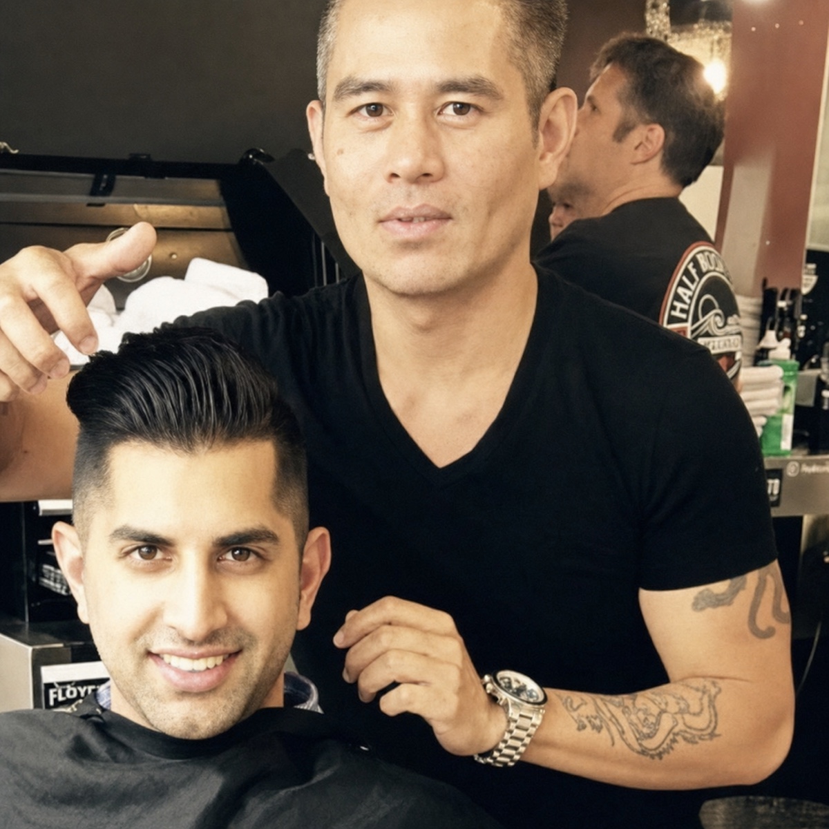 Vincent Nguyen with a client after finishing a sculpted men's haircut