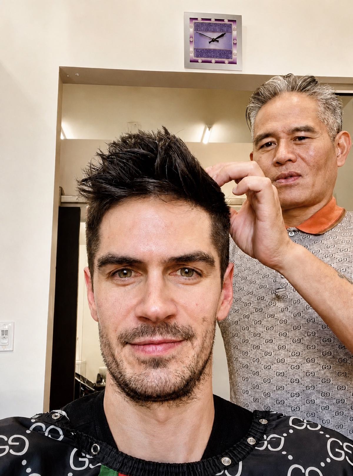 Vincent Nguyen refining the textured top of a client's finished short haircut